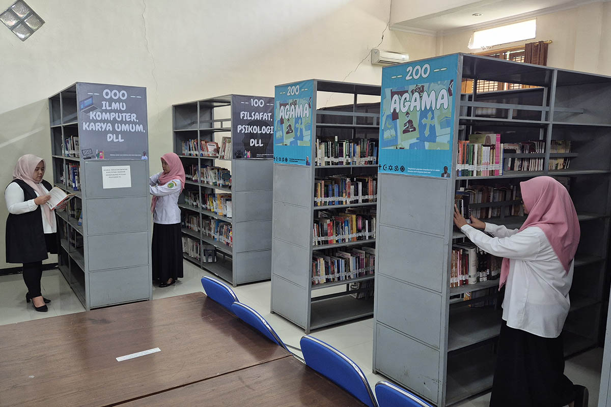 GUDANG ILMU: Pengunjung dan petugas tampak mencari koleksi buku bacaan di Perpusda Kota Pasuruan Sekargadung, Kecamatan Purworejo.