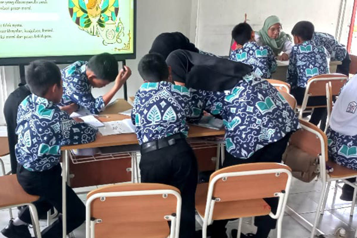 BELAJAR: Aktivitas KBM di SRMP 28 Kota Pasuruan dengan seragam baru yang mereka kenanakan. Dari rencana delapan jenis seragam, masih menyisakan dua jenis seragam yang belum dibagi.