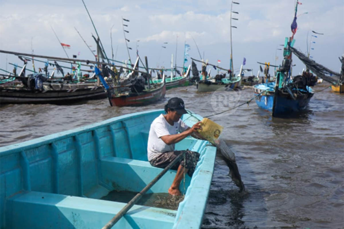 MANFAATKAN WAKTU: Selama libur melaut, nelayan di pesisir Pasuruan sementara banyak beraktivitas lain. Termasuk merawat perahu dan kapal.