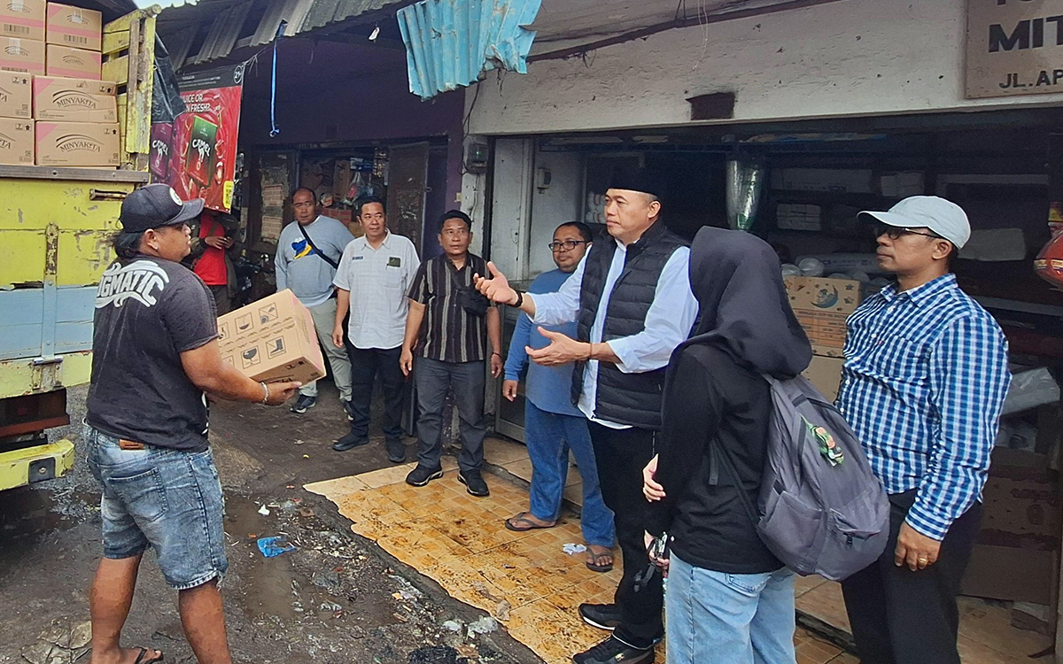 Petugas saat memantau distribusi minyak kita di Pasar Bangil.