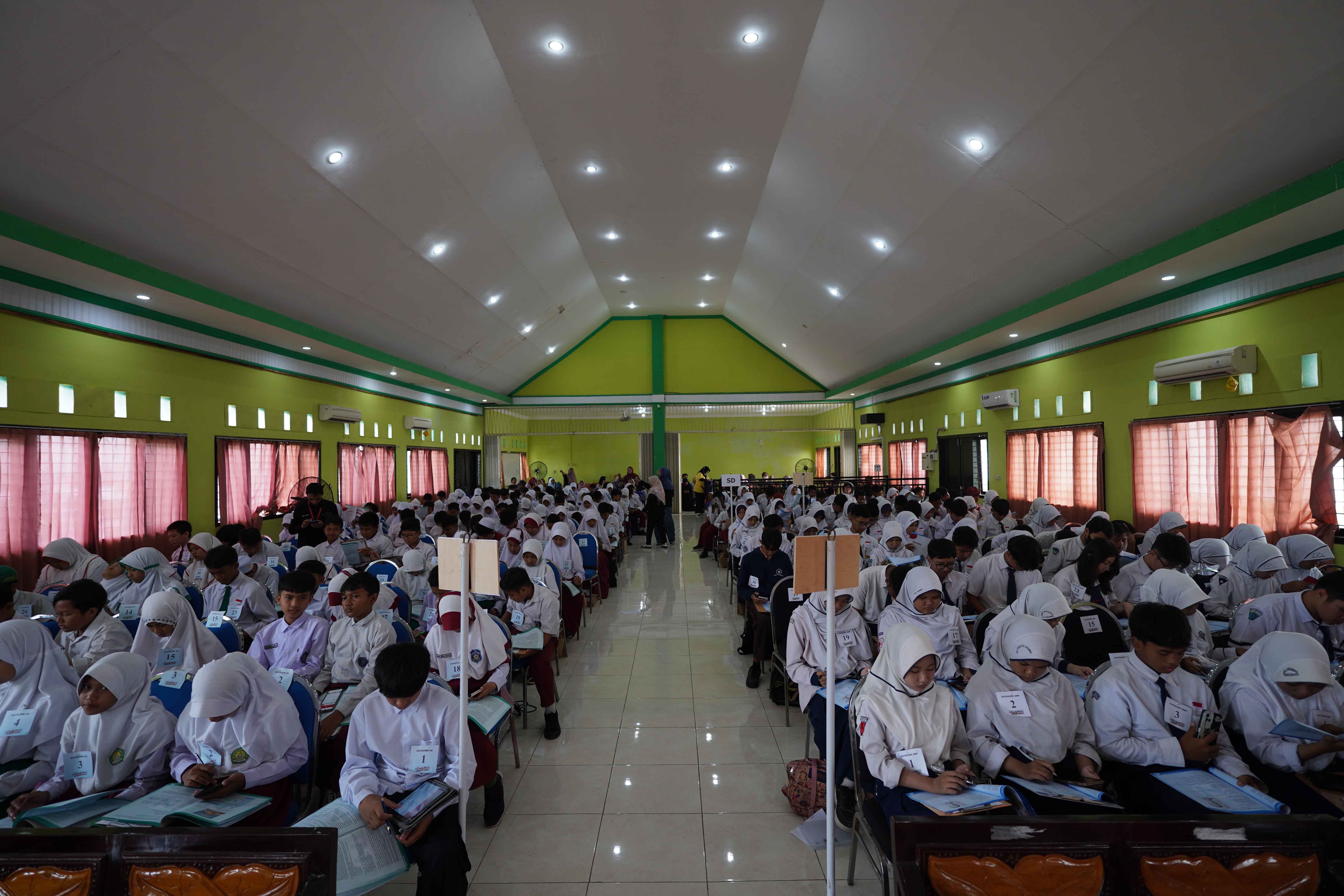 SERIUS: Ratusan siswa SD dan SMP sederajat Kota Probolinggo mengerjakan soal babak final Kompetisi TKA 2026 di Aula Lantai 3 SMK Negeri 2 Kota Probolinggo, Senin (16/2).