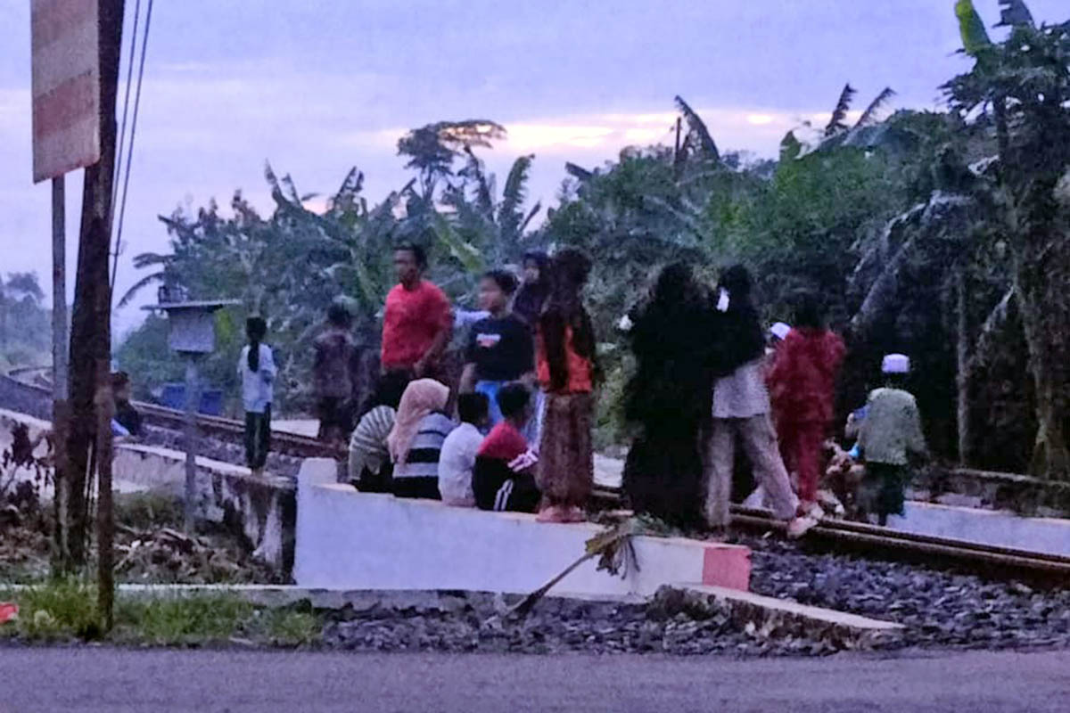 BERBAHAYA: Sejumlah warga saat menjadikan lintasan rel kereta api sebagai tempat tongkrongan. Hal itu, sangat membahayakan, sehingga dilarang.