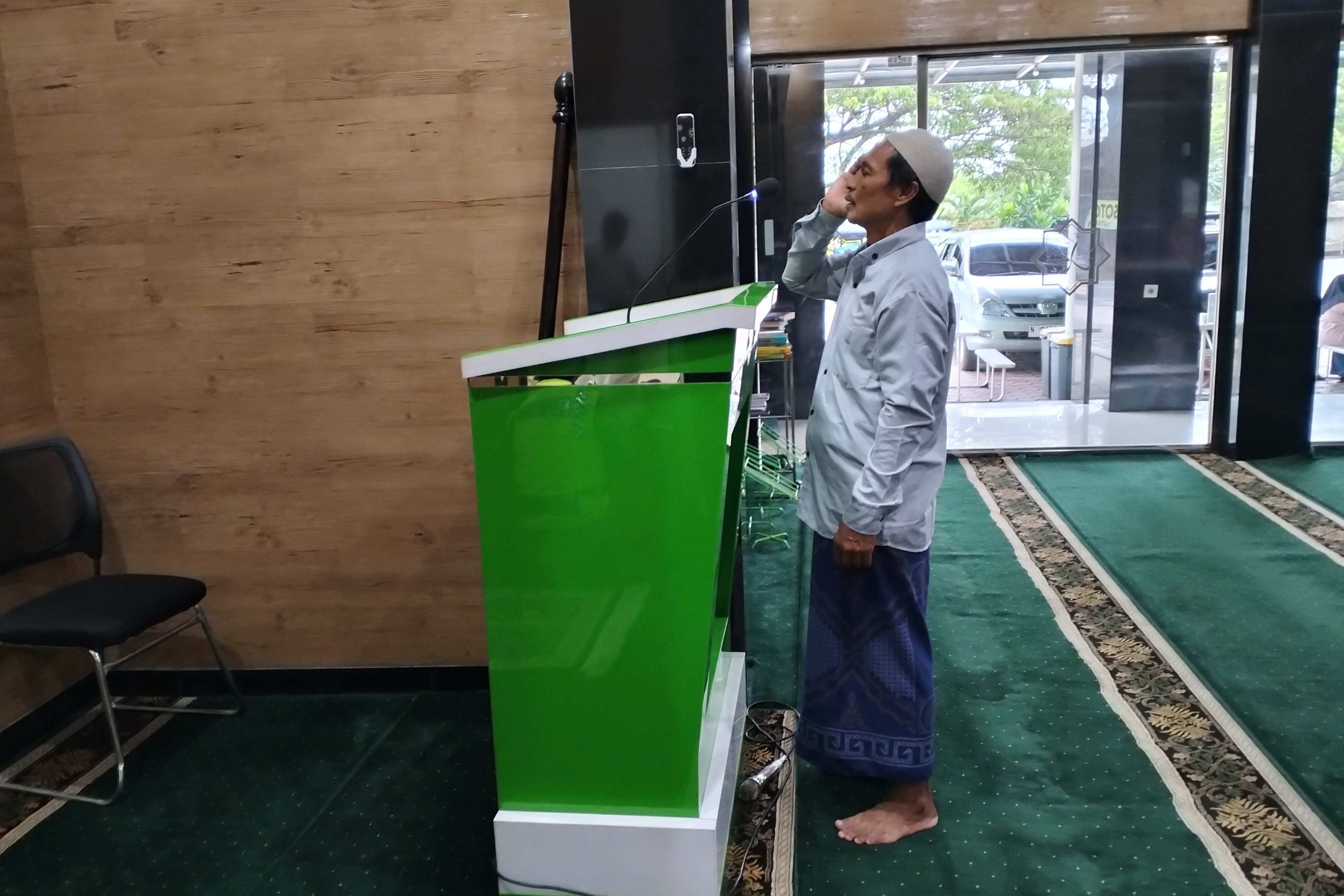 PANGGILAN SALAT: Chaerus Zaman, mengumandangkan azan di Masjid Siti Aminah Al Askar di Desa Sukokerto.