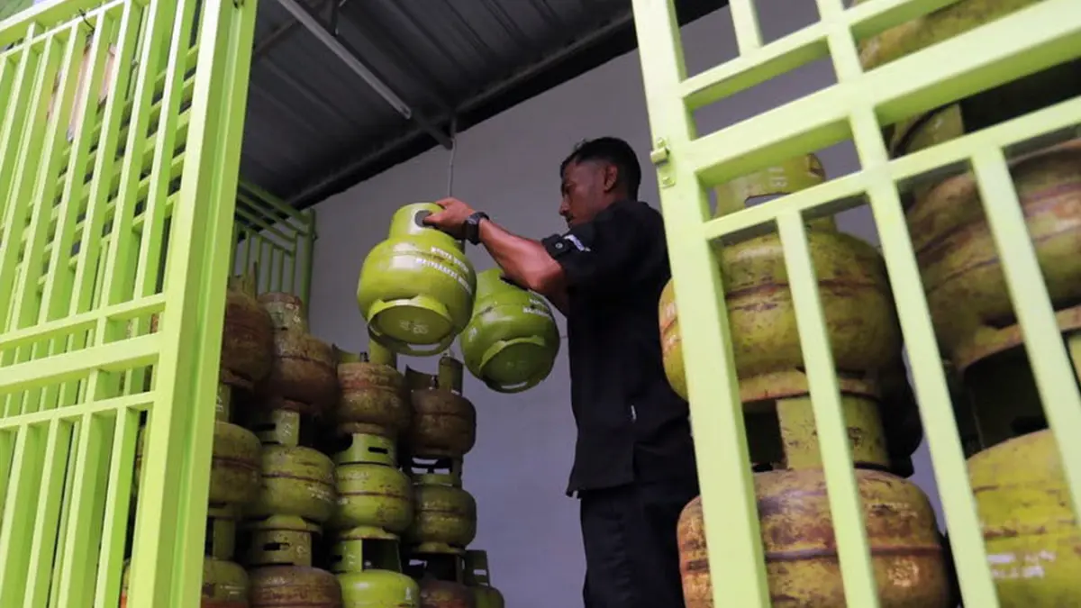 Nampak salah satu pegawai di salah satu distributor gas elpiji 3 kg di wilayah Kraksaan menata kembali gas yang ada di tempatnya.
