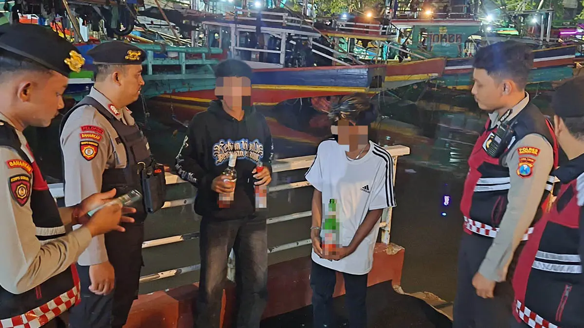 TINDAK: Petugas gabungan saat melakukan razia dan mendapati dua pemuda yang diduga pesta miras. Mereka digiring ke Mapolres Pasuruan Kota untuk pembinaan. (Polres Pasuruan Kota for Radar Bromo)