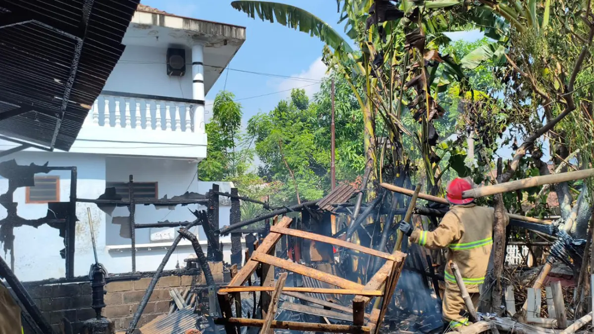 SEMPROT: Petugas Damkar Satpol PP Kota Probolinggo saat melakukan pemadaman di dapur rumah milik Muhammad Drajat, 30, warga Kelurahan Kedungasem, Kecamatan Wonoasih, Sabtu (23/5). (Inneke Agustin/ Radar Bromo)