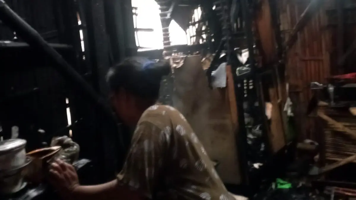 TERBAKAR: Mariana, 55, warga Desa Sumurmati, Sumberasih, Kabupaten Probolinggo mengecek dapurnya setelah terbakar, Jumat (22/5) petang.