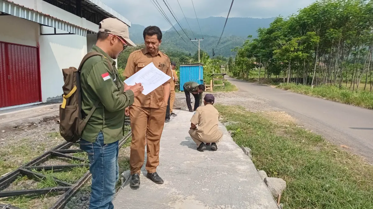 CEK PEMBANGUNAN: Kepala Desa Gondosuli Muhammad mengecek hasil pembangunan Rabat Beton di dusun Krajan RT/ RW 1/1. (Foto : Didik Purwanto/Jawa Pos Radar Bromo)