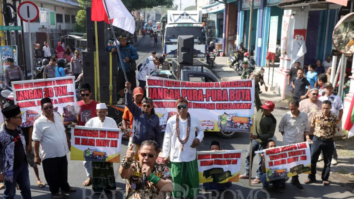 TUTUP JALAN: Warga saat menggelar tahlilan dan menutup JLS Pasuruan yang dipenuhi truk besar imbas pengalihan arus lalin perbaikan jembatan Bok Wedi. (Mokhamad Zubaidillah/ Radar Bromo)
