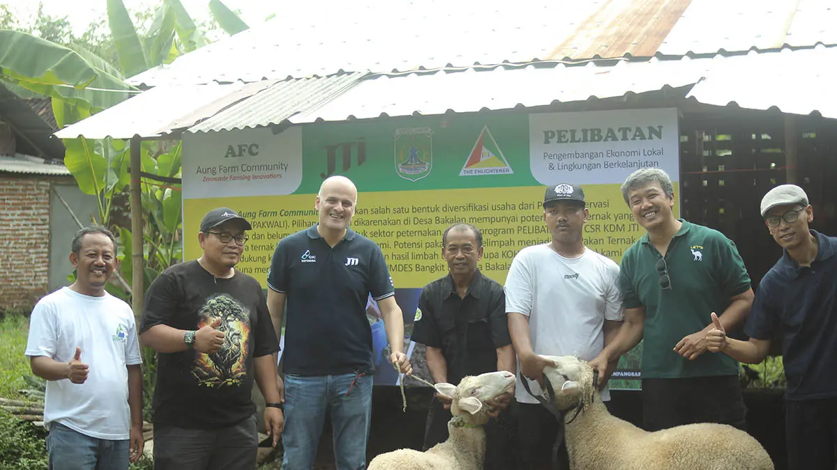 AKSES INFORMASI : Manajemen PT JTI Indonesia bersama pengurus Bumdes Bangkit bersama di depan usaha budi daya ikan sungai. (Foto: Japan Tobacco International for Jawa Pos Radar Bromo)