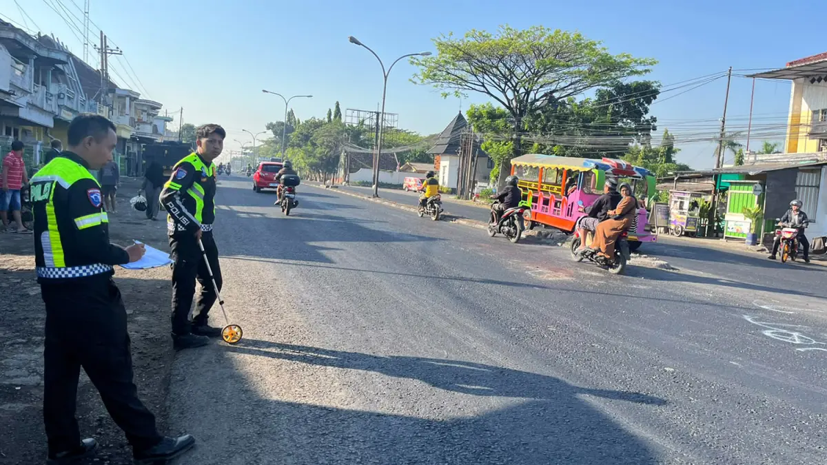 Petugas kepolisian saat melakukan olah TKP insiden kecelakaan yang membuat seorang pelajar luka-luka. 
