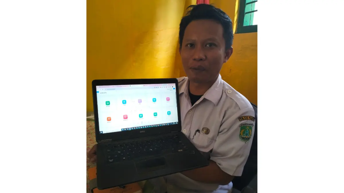 INOVATOR: Kepala SDN Baujeng I, Akhmad Nasor menunjukkan aplikasi yang dirancangnya melalui laptop. (Rizal Fahmi Syatori/Jawa Pos Radar Bromo)
