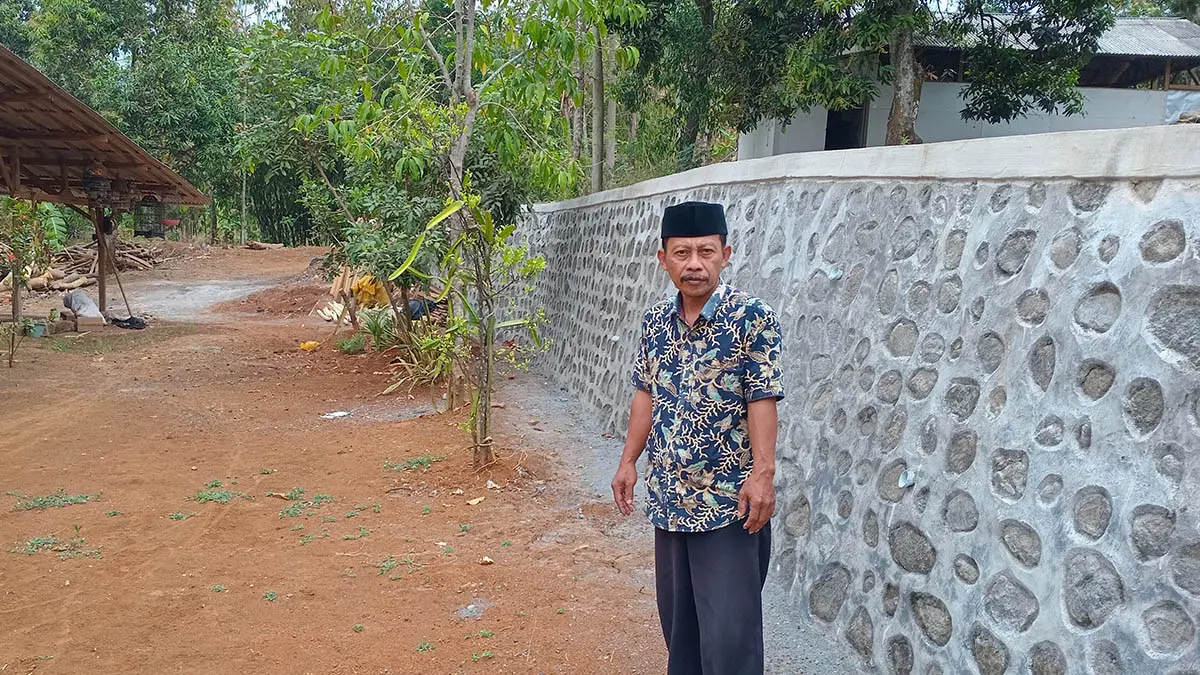 KOKOH: Kepala Desa Palangbesi, Saman menunjukkan hasil pembangunan TPT didusun Kranggan, RT/RW 12/4, yang sebelumnya berupa tebing tanah. (Foto: Didik Purwanto/Jawa Pos Radar Bromo)