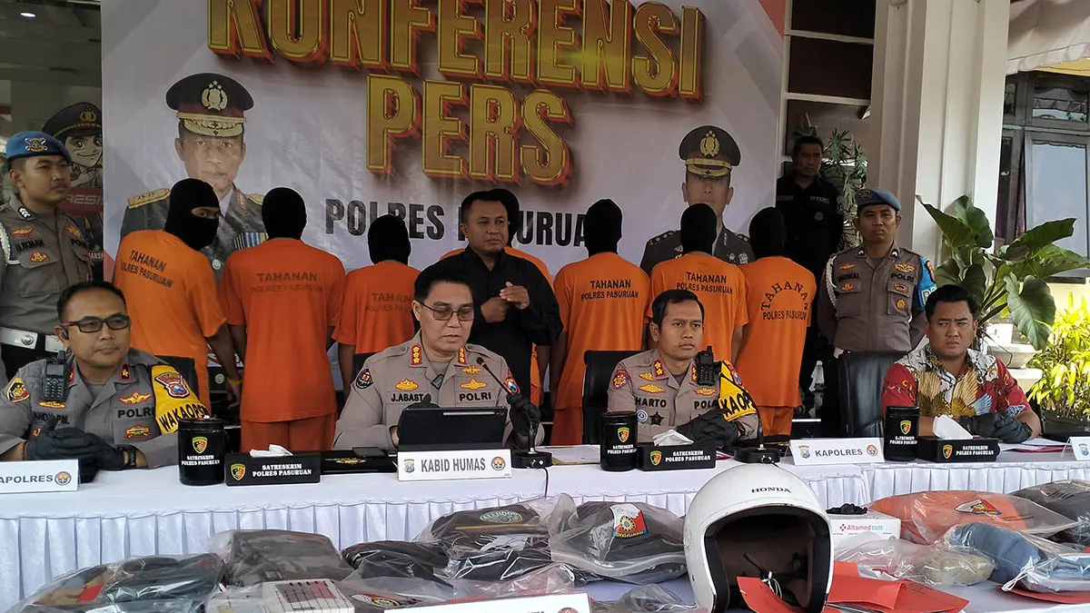 HARUS BERTANGGUNG JAWAB: Konferensi pers di Mapolres Pasuruan merilis ungkap kasus pelaku tindak pidana kerusuhan Sukorejo, Jumat (14/8).&nbsp; Nampak tujuh tersanghka dan sejumlah barang bukti yang diamankan polisi. (Foto: Rizal F Syatori/Jawa Pos Radar Bromo)