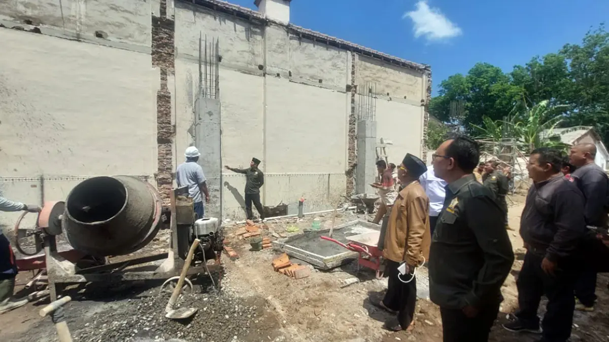 CEK KEKUATAN: Salah satu anggota Komisi III DPRD Kota Probolinggo saat mengecek kekuatan salah satu tiang penyangga proyek rehab gedung kantor DPRD Kota Probolinggo, Selasa (24/8). (Arif Mashudi/ Radar Bromo)