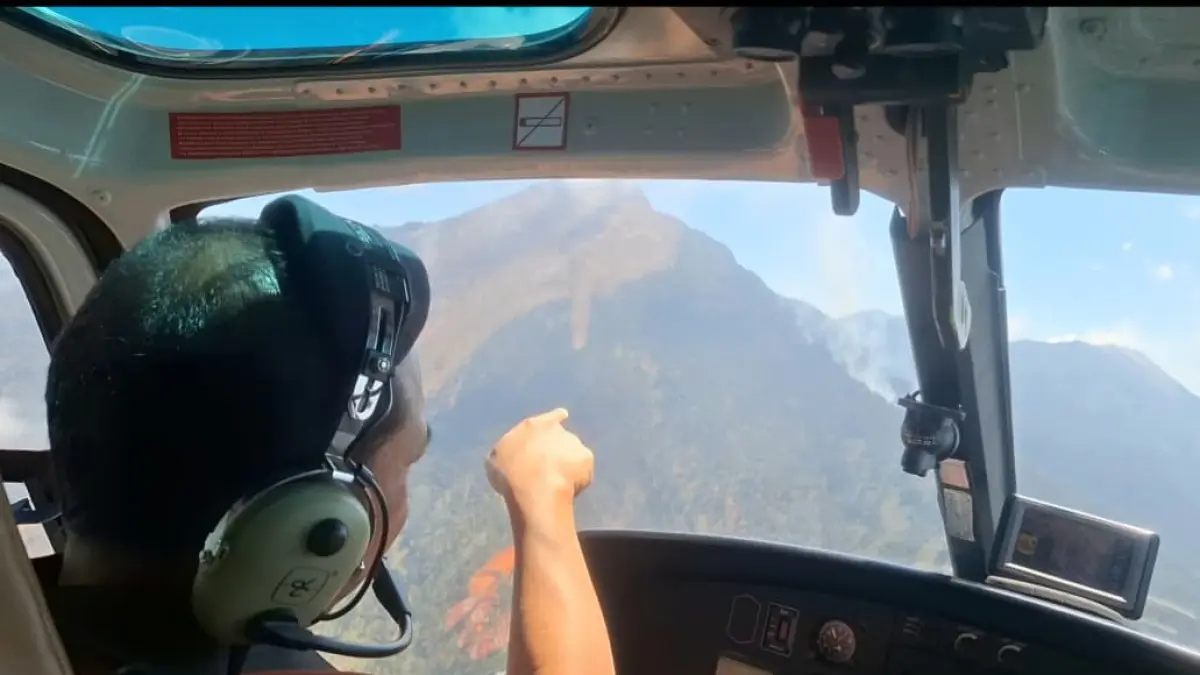 Petugas BPBD Jatim melakukan pemantauan kebakaran hutan dari helikopter saat melakukan operasi water bombing untuk padamkan api. (Istimewa)