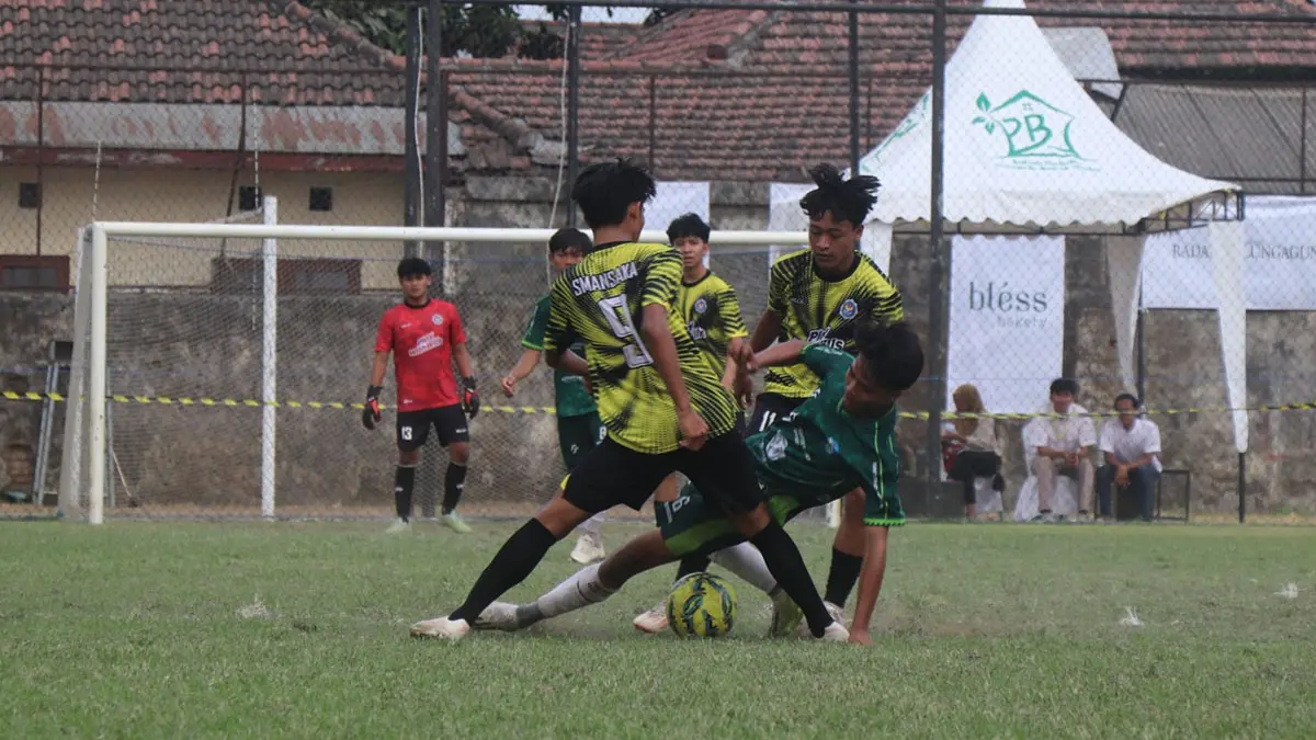 SENGIT: Dua pemain SMAN 1 Kauman mengepung gelandang SMAN 1 Trenggalek dalam perebutan tiket final Bahlil Mini Soccer Asyik Menuju Puncak Zona 3 Tulungagung, (8/9). (DR Perdana/ Radar Tulungagung)