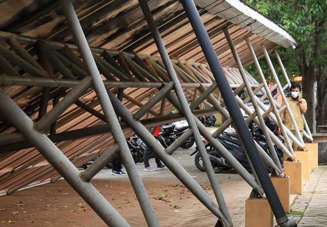 AMBRUK: Angin kencang yang menerjang Kota Pasuruan sejak pagi membuat kanopi tempat parkir sepeda motor Pemkot Pasuruan ambruk, Selasa (2/2) pukul 11.00. Beruntung, tidak ada korban jiwa maupun benda akibat peristiwa itu. (Foto: M Zubaidillah/Jawa Pos Rad