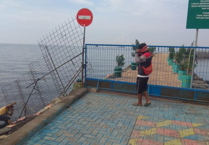 MOKONG: Pemancing yang mencoba menerabas masuk di ujung kawasan Pelabuhan Probolinggo. (Foto: Rizky Putra Dinasti/Jawa Pos Radar Bromo)