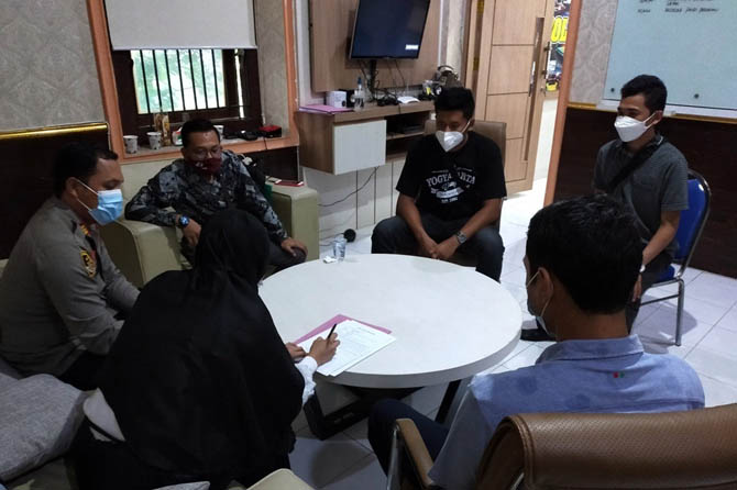 BERDAMAI: Korban Dv dan terlapor Dn (sama-sama membelakangi kamera) saat meneken untuk tak melanjutkan kasus penganiayaan ke proses hukum di Mapolsek Prigen, (4/3). (Rizal Syatori/ Radar Bromo)
