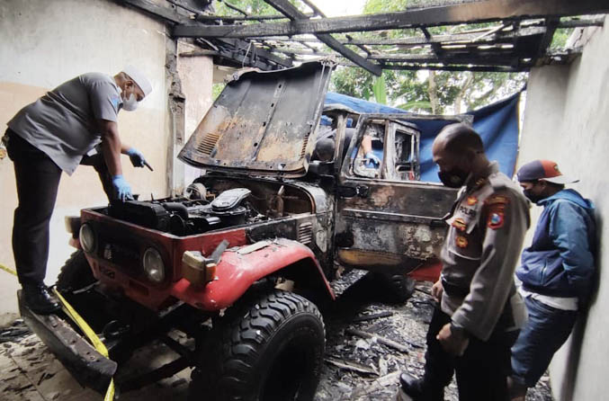 LUDES: Petugas Polres Probolinggo melakukan olah TKP di lokasi kejadian. Nampak mobil Toyota Land Cruiser milik korban yang ludes terbakar. (Foto: Arif Mashudi/Jawa Pos Radar Bromo)