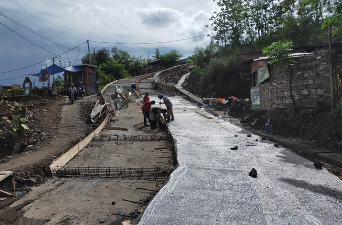 PAKAI BETON: Pekerja menyelesaikan pekerjaan rigid jalan kabupaten Jurang Wak Kawi yang berlokasi di Desa Sumbergedang, Kecamatan Pandaan. (Foto: Rizal F Syatori/Jawa Pos Radar Bromo)