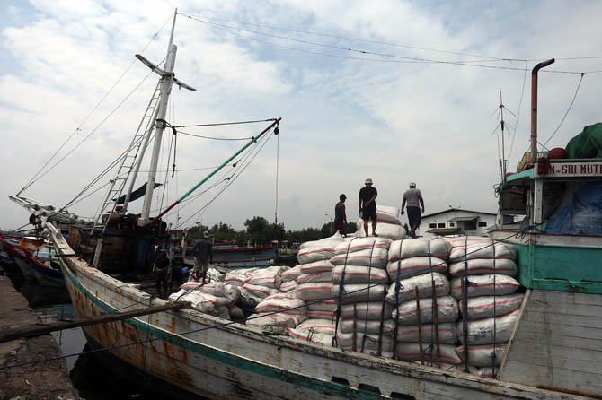 DIBONGKAR: Sejumlah pekerja membongkat muatan Kapal LM. Sri Mutiara Alam 3 di Pelabuhan Tanjung Tembaga, Probolinggo, (25/12). (Zainal Arifin/ Radar Bromo)