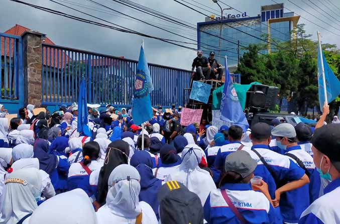 UNJUK RASA: Buruh yang berunjuk rasa di depan pabrik PT Intim Harmonis Foods di Desa Lemahbang, Sukorejo, Senin (21/3) pagi. (Foto: Rizal F Syatori/Jawa Pos Radar Bromo)