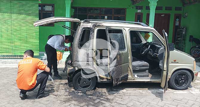 OLAH TKP: Petugas Polsek Besuk dan tim Inafis Polres Probolinggo melakukan olah TKP di lokasi mobil milik Fathullah, 44, terbakar. Sejumlah barang bukti pun diamankan. (Agus Faiz Musleh/ Radar Bromo)