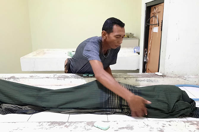 DISELIDIKI: Petugas Polsek Wonoasih menyelidiki penyebab meninggalnya F, 10, yang diduga menenggak miras oplosan. (Fahrizal Firmani/Radar Bromo)