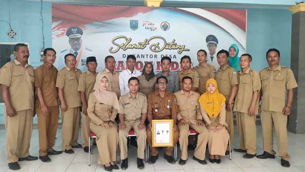 KOMPAK: Kepala Desa Maron Kidul Ridwanto (duduk tengah) berfoto bersama perangkat desa. (Pemerintah Desa Maron Kidul for Jawa Pos Radar Bromo)