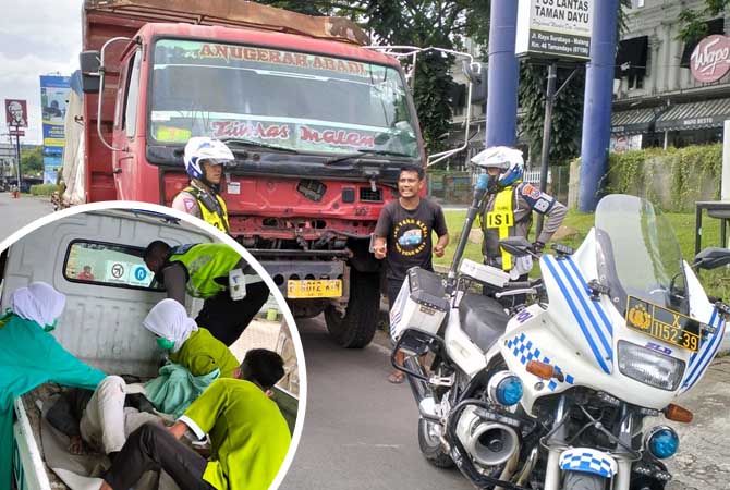 BERI KETERANGAN: Sopir truk Irfan Imam Subekti memberi penjelasan kepada polisi usai dihentikan di simpang empat Taman Dayu. Ia mengaku tak mengetahui jika bagian belakang truknya tertabrak motor. (Rizal Syatori/ Radar Bromo)