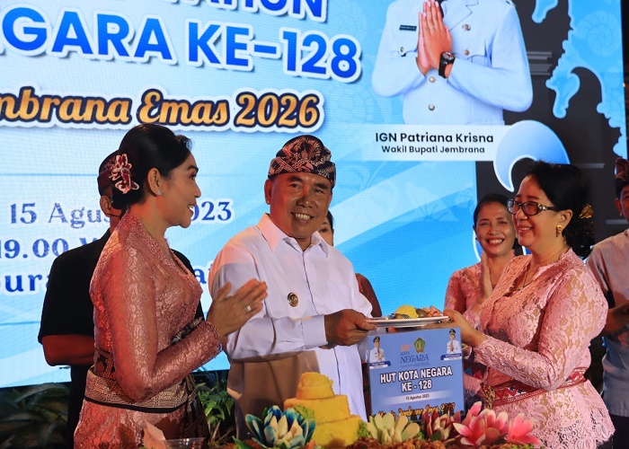 TUMPENGAN : Bupati Jembrana I Nengah Tamba menyerahkan potongan tumpeng kepada Ketua DPRD Jembrana Ni Made Sri Sutharmi pada malam puncak peringatan HUT Kota Negara, Selasa (15/8).