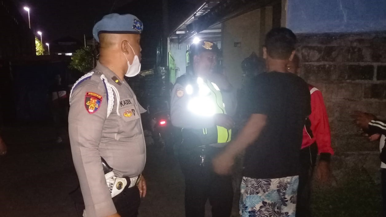 Tim UKL Polsek Denpasar Timur mengamankan Adi (kaos hitam), pemilik warung tuak yang mengamuk di rumahnya di Denpasar, Bali.