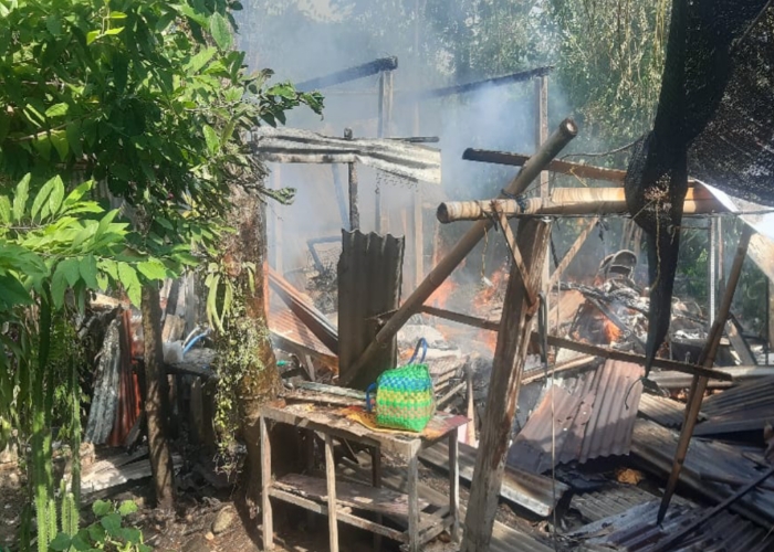 HANGUS : Proses pemadaman api yang turut dibaantu oleh aparat kepolisian.
