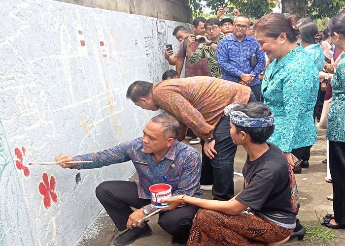SENI : Pembuatan mural dalam acara Mural Temesi Mewali Ka Guru, Jumat (15/3) di wantilan Desa Adat Temesi.