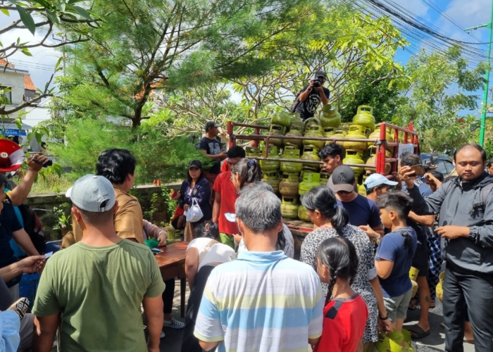 ANTRE: Warga Kelurahan Legian, Kecamatan Kuta yang rela antre di operasi pasar untuk mendapatkan LPG 3 Kg di Kantor Lurah Legian, Senin (3/6).