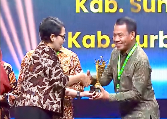 Pj Bupati Buleleng Ketut Lihadnyana menerima trofi penghargaan Program Indonesia Pintar