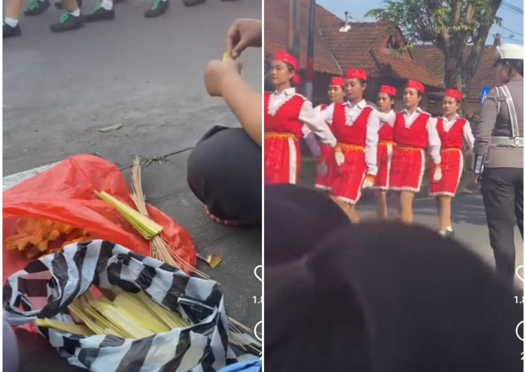 Ibu-ibu nonton gerak jalan sambil nyait canang