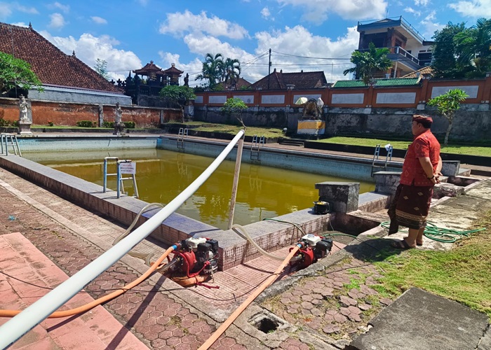 DIKELUHKAN : Proses pengurasan kolam renang Lila Arsana, Klungkung.