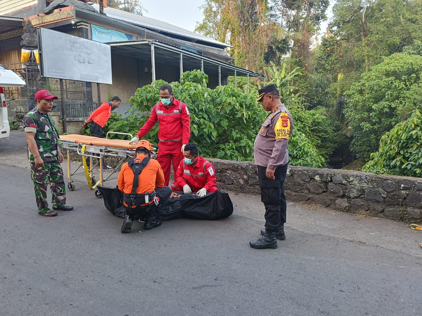TRAGIS: Petugas mengevakuasi jenazah Yanto yang jatuh ke sungai usai dikejar gerombolan diduga geng motor. (Bali Express/Humas Polres Badung)