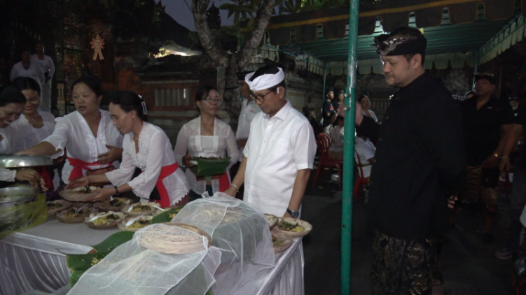 Paslon Bupati dan Wakil Bupati Badung Adicipta saat mencicipi bubur Bali sebelum menyapa masyarakat di Wantilan Desa Adat Mengwi, Rabu (23/10).