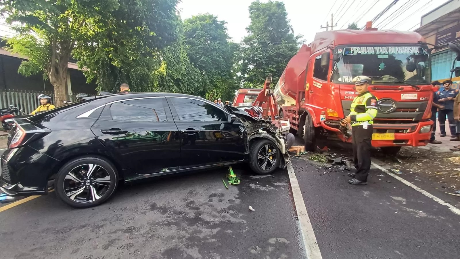 KECELAKAAN: Kecelakaan antara mobil, sepeda motor, dan truk tangki BBM di Jalan S Parman, Banyuwangi, Kamis pagi (9/1) hingga membuat mobil Civic ringsek.