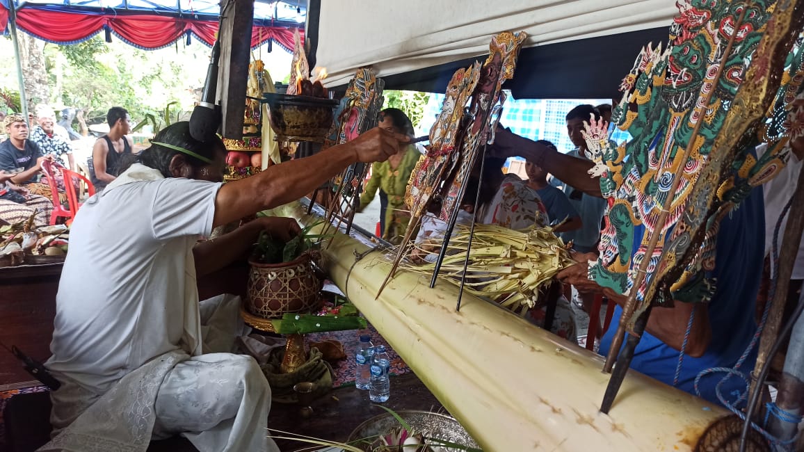 Ritual tiga bulanan dengan menggunakan tualen sebagai sarana melukat tirta wayang untuk bayi yang tiga bulan