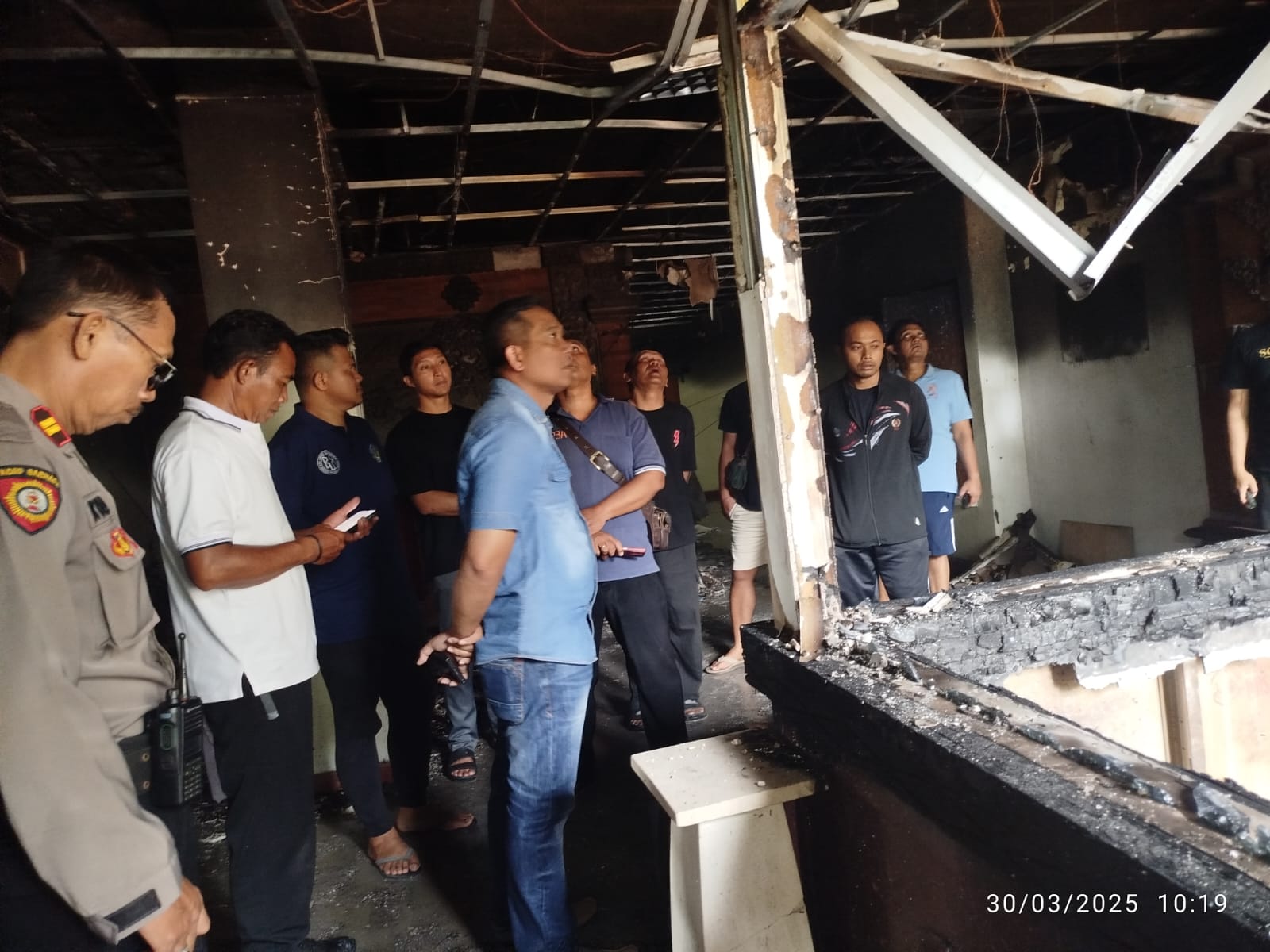 HANGUS: Kapolsek Denpasar Timur Kompol Tomiyasa (kemeja biru) turun langsung ke lokasi Ruang Biro Hukum Kantor Gubernur Bali yang hangus terbakar. (Bali Express/Istimewa)