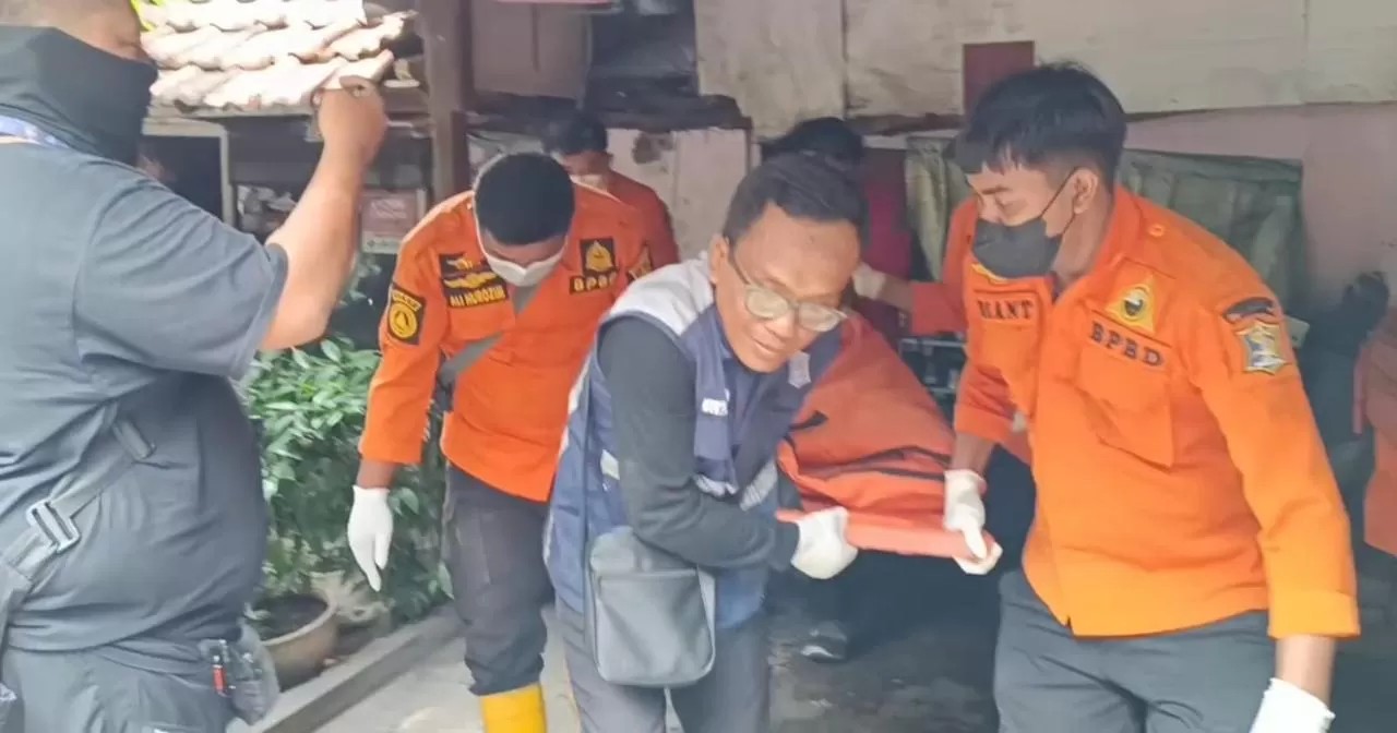 Petugas mengevakuasi korban yang diduga dimakan anjing peliharaannya di Rungkut Surabaya.