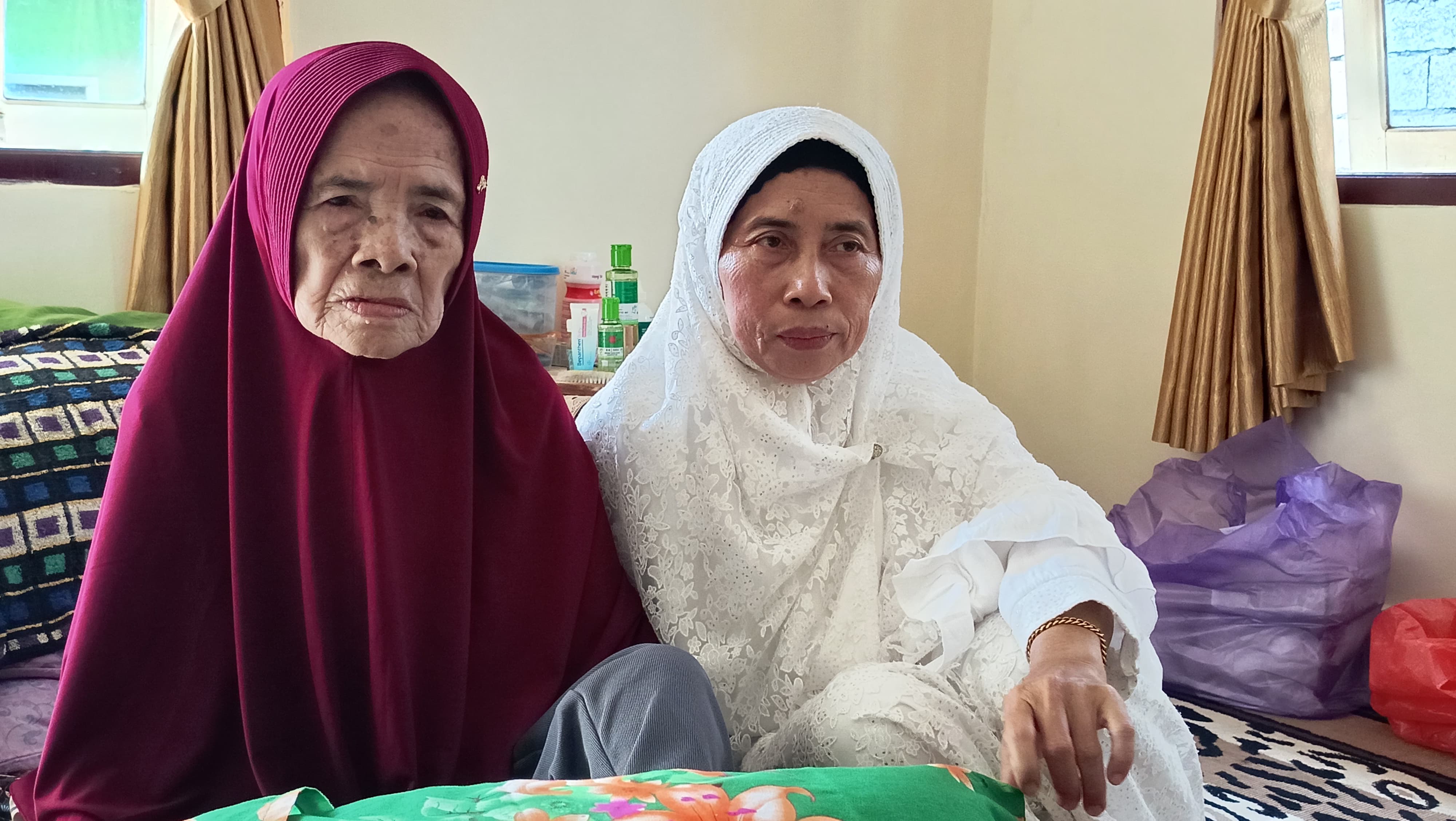 Siti Maimunah (Hijab merah) dan anaknya, Mariati (hijab putih).