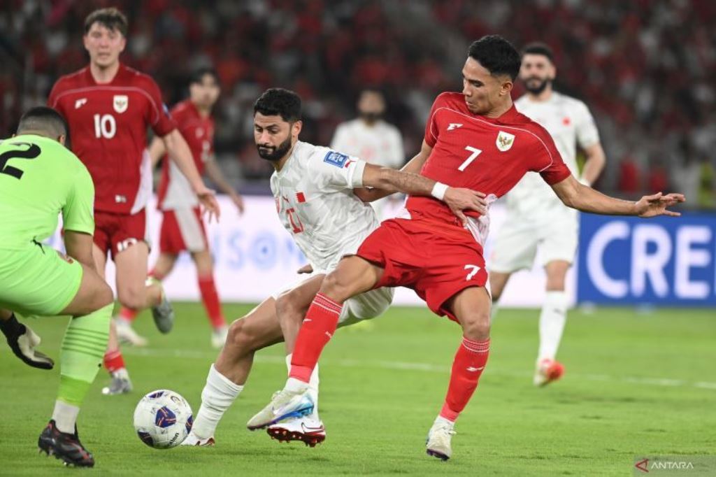 Pesepak bola Timnas Indonesia Marselino Ferdinan (kanan) berebut bola dengna pesepak bola Timnas Bahrain Ahmed Bughammar (tengah) dalam pertandingan Grup C putaran ketiga Kualifikasi Piala Dunia 2026