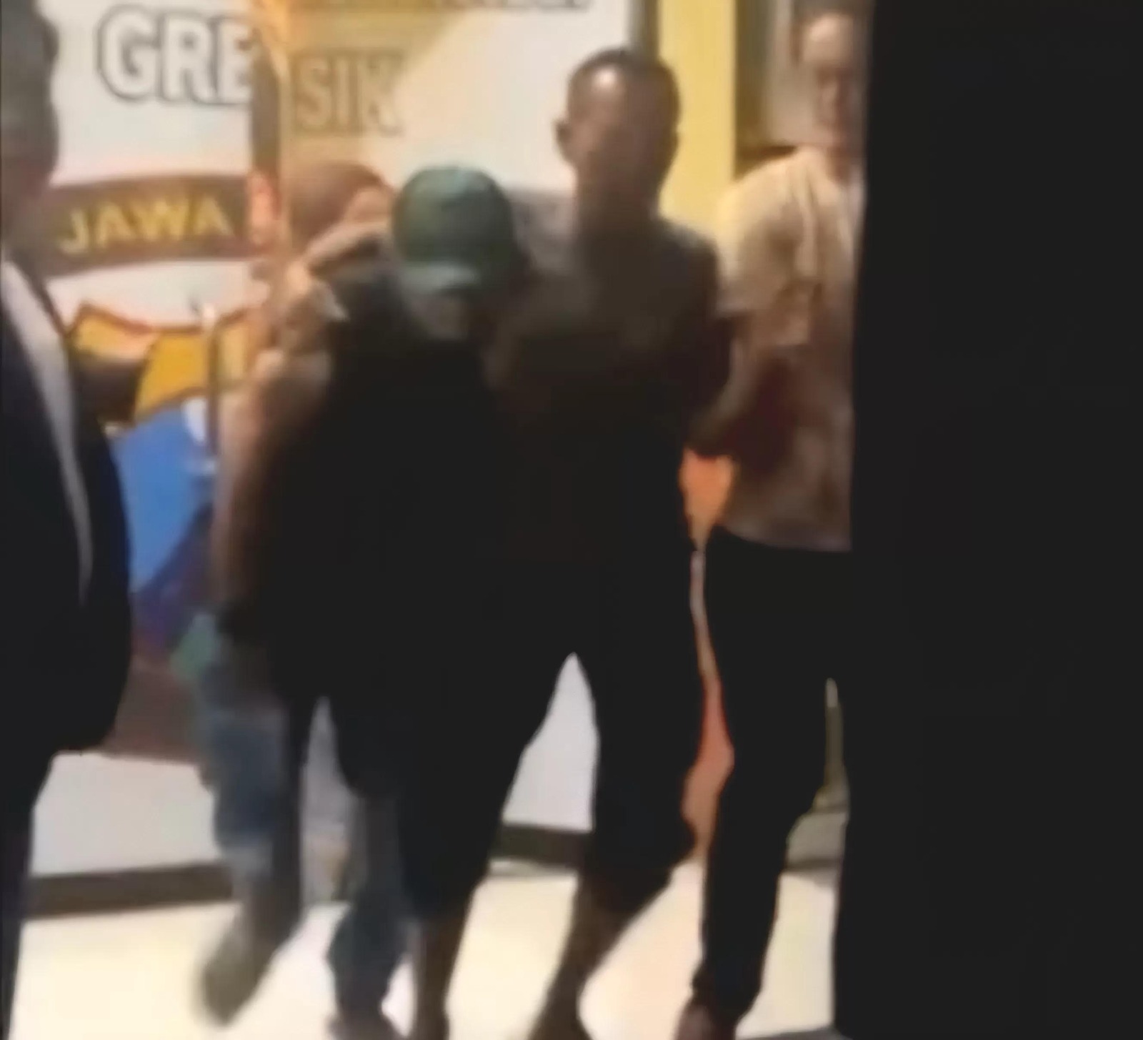 Sejumlah warga menggelandang bos toko buah ke kantor polisi.