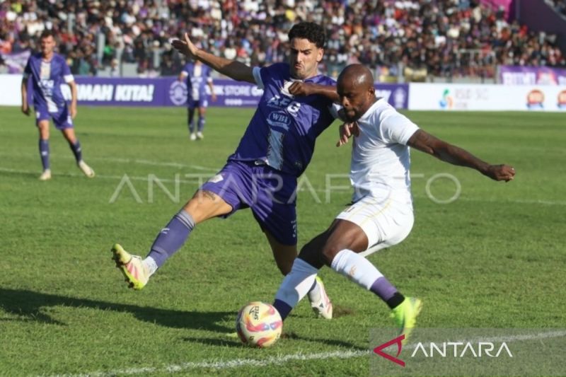 Pesepak bola Persik Kediri Francisco Pereira (kiri) berebut bola dengan pesepak bola Asian Warriors FC Greg Nwokolo (kanan) pada pertandingan persahabatan di Stadion Brawijaya Kota Kediri, Jawa Timur.